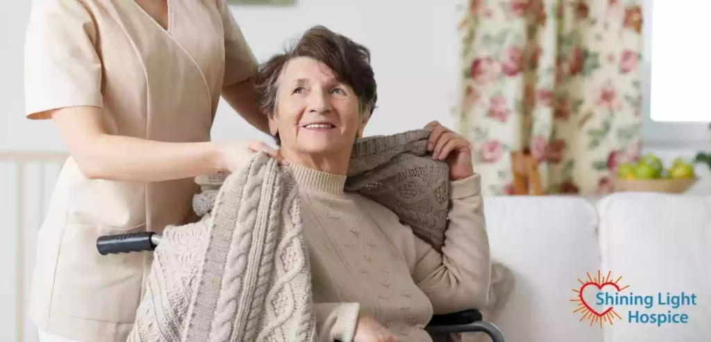 Caregiver covering senior woman with a blanket Our Difference