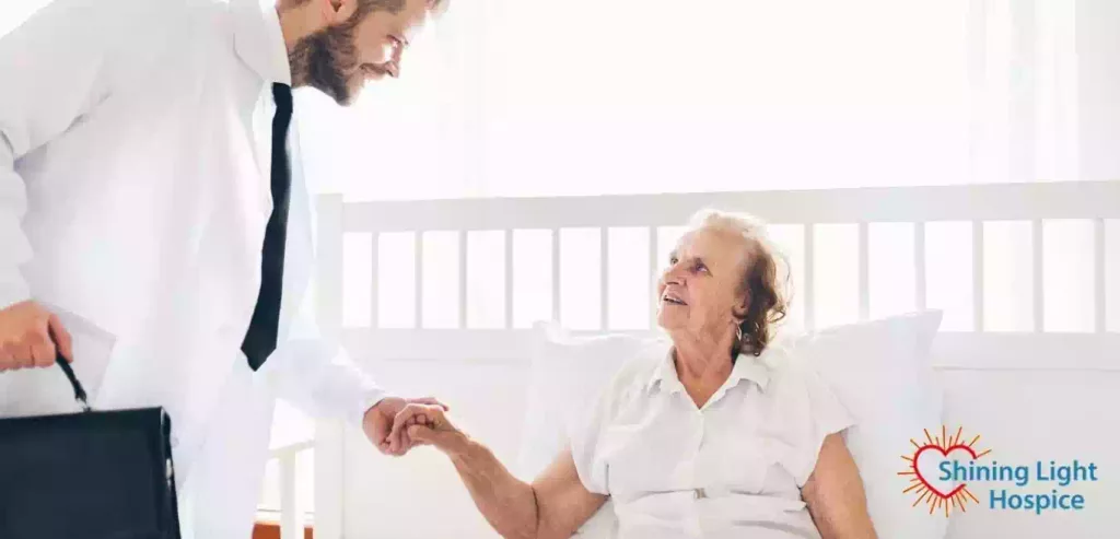 Doctor Visiting Elderly Patient at Home Predicting End Of Life